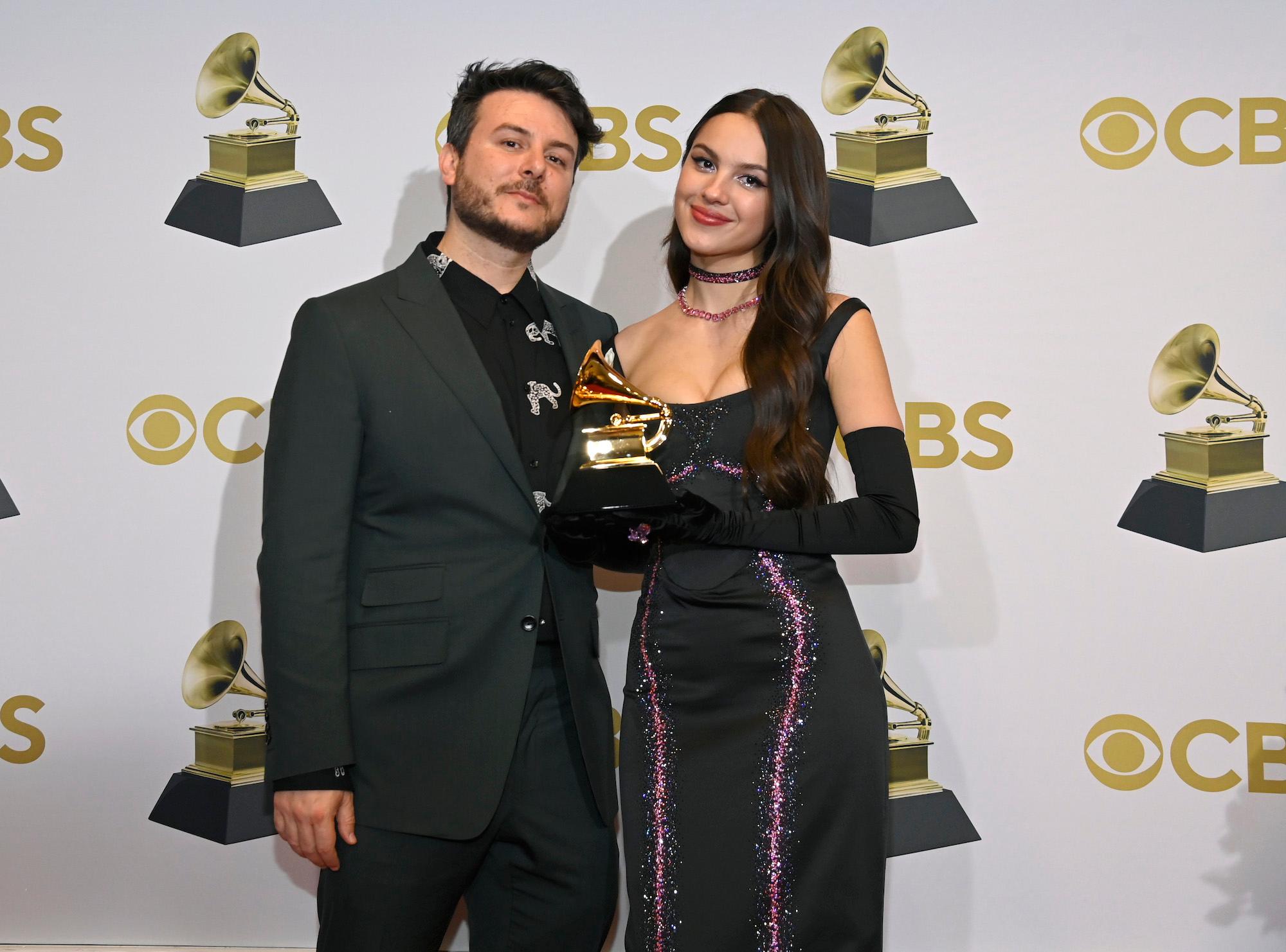 Dan Nigro and Olivia Rodrigo posing with their Grammy at the 64th Annual Grammy Awards
