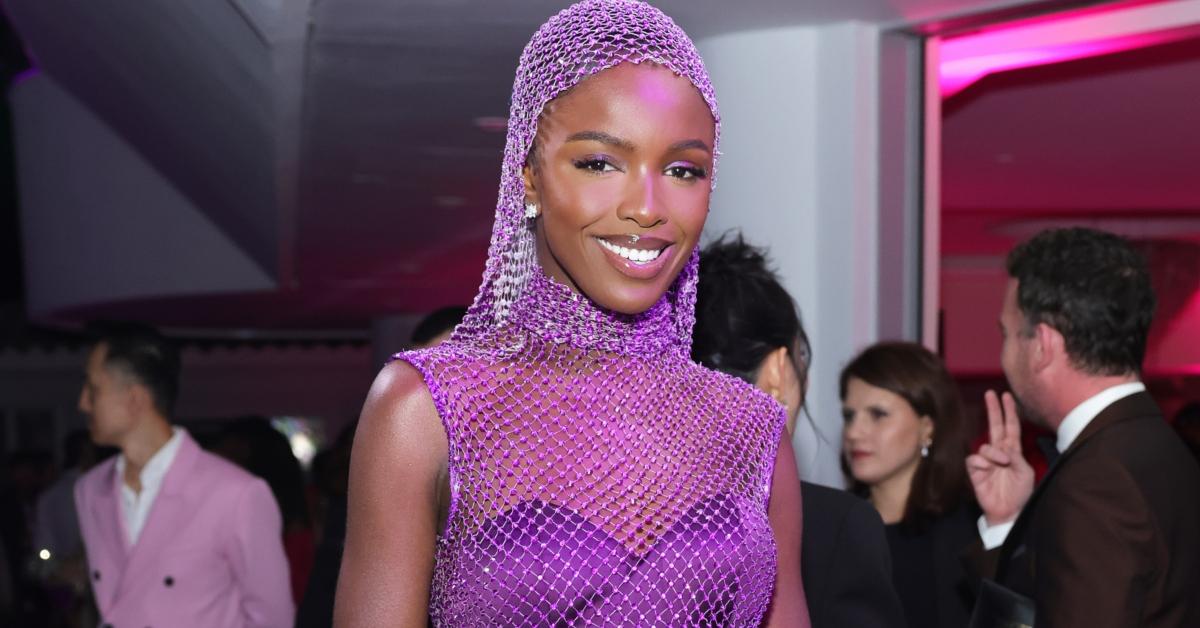 Leomie Anderson wears a purple sheer outfit with sheer head covering at a special birthday event for Naomi Campbell.