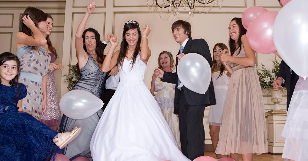 A group of people dancing during a quinceañera.