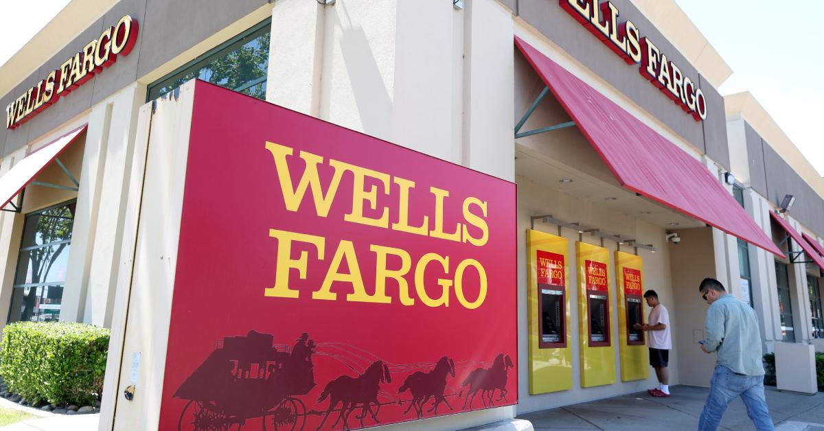 Wells Fargo customers use the ATM outside the bank.