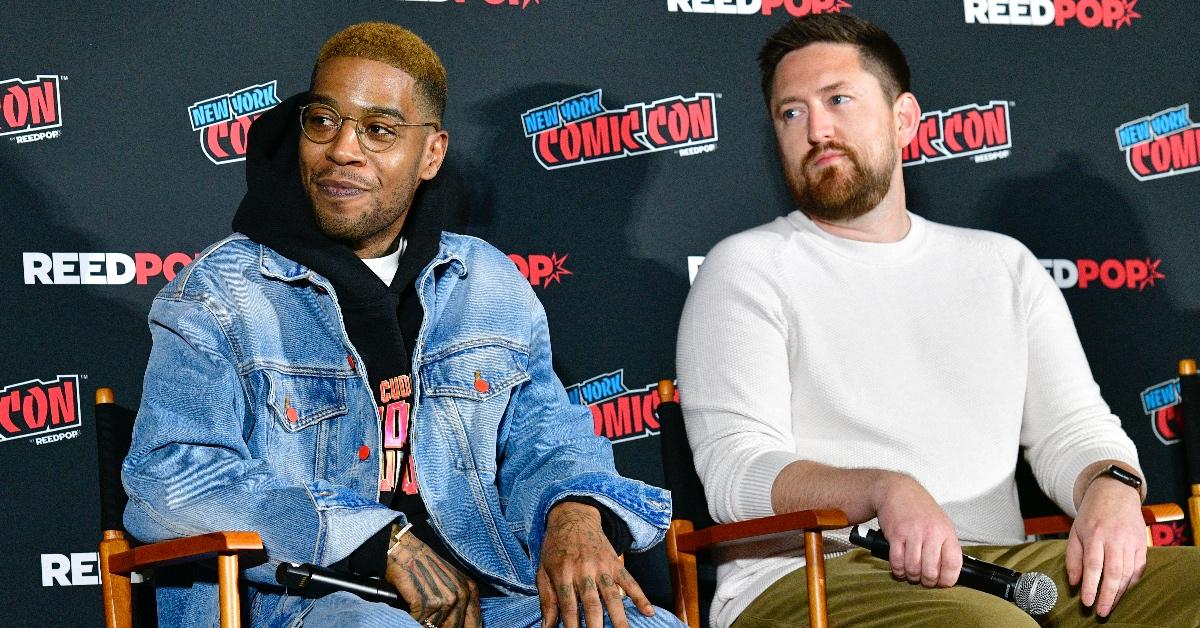 Kid Cudi and Marco Locati sitting in director's chairs at New York Comic Con.